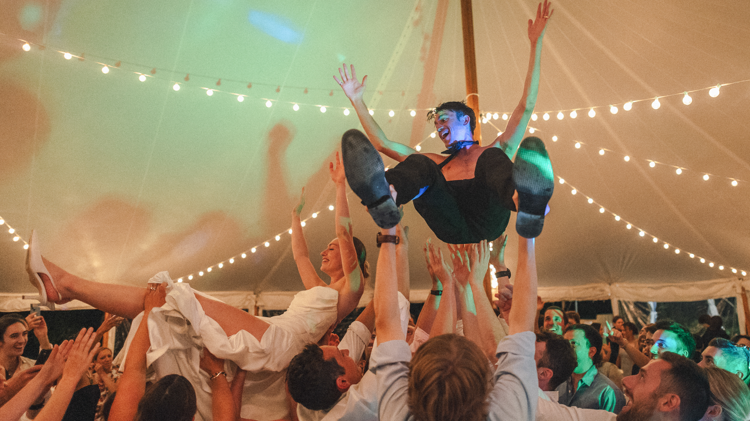 24 Amazing Farm Wedding Venues Near Boston 1 Guests hoist bride and groom on chairs under tent