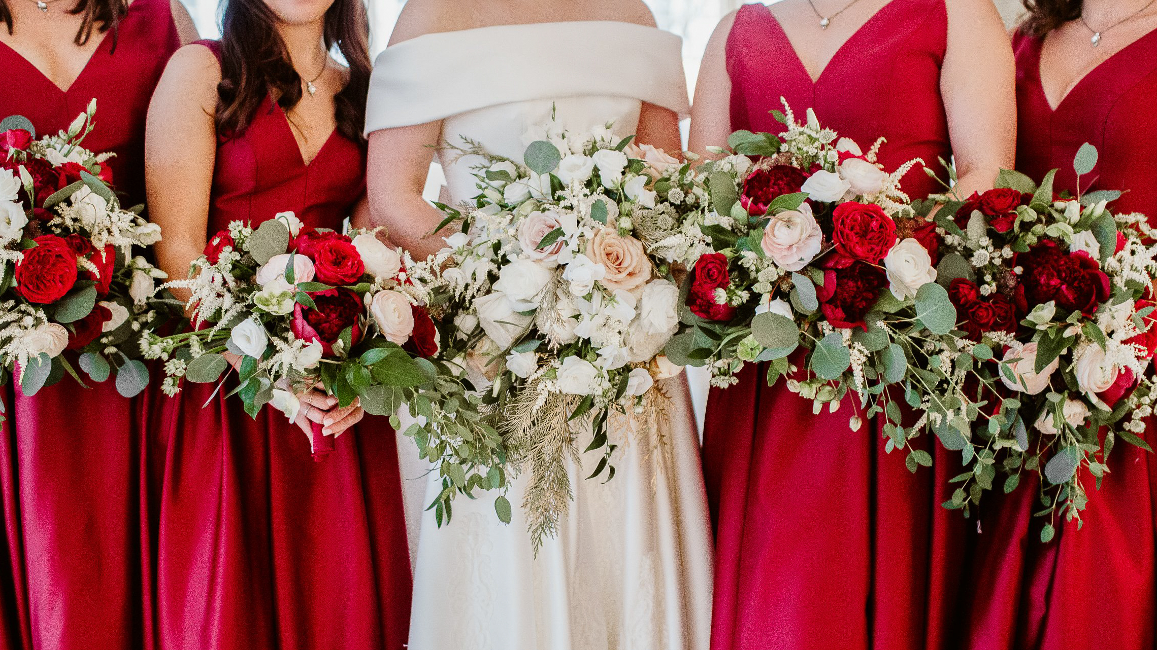 Boston Wedding Florists: 2025’s Comprehensive Guide for Your Big Day 1 Bride and bridesmaids in red hold red and white bouquets