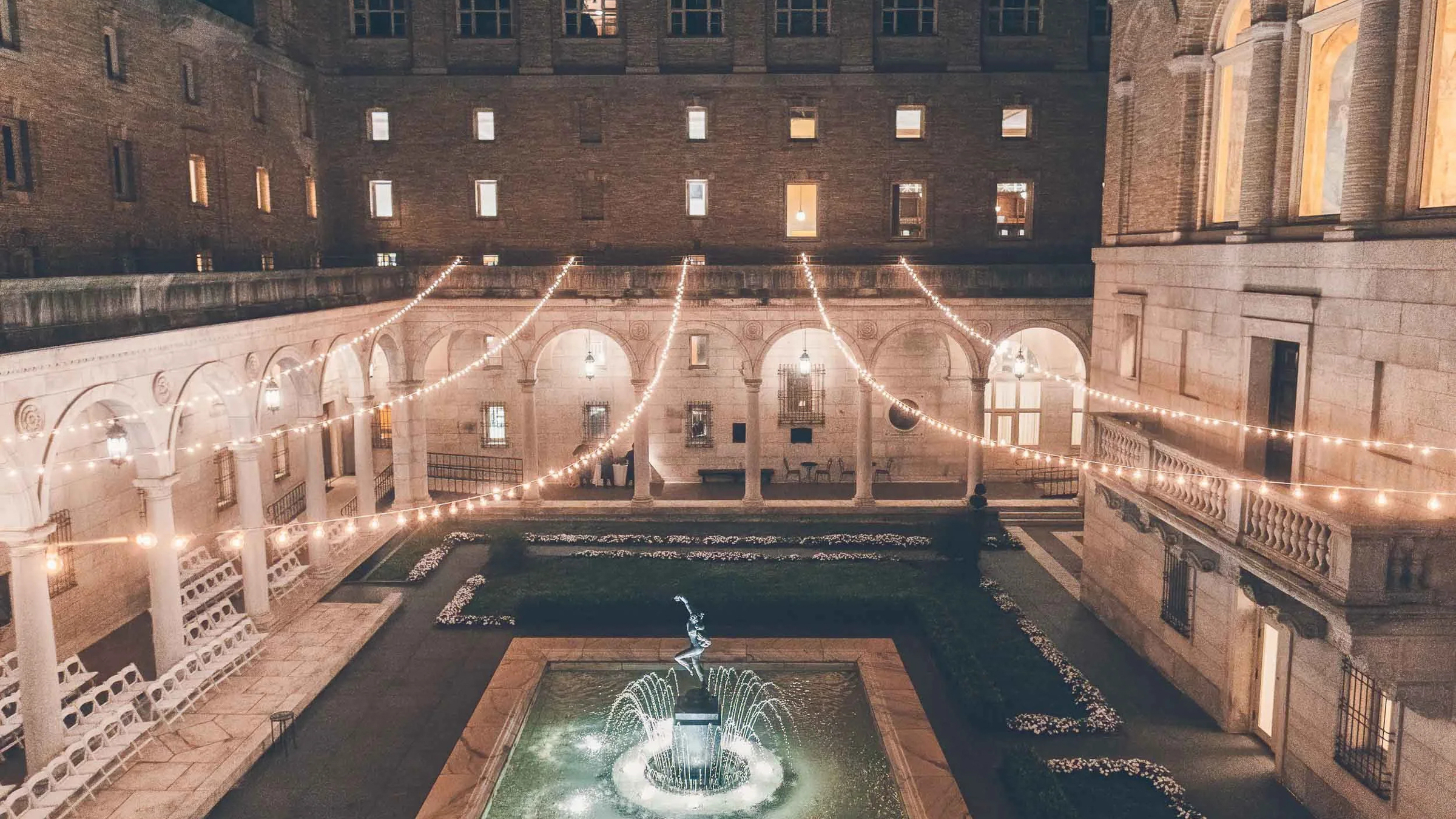 How to Find a Boston Wedding Venue 1 String lights over stone courtyard fountain at night, possibly Boston Public Library