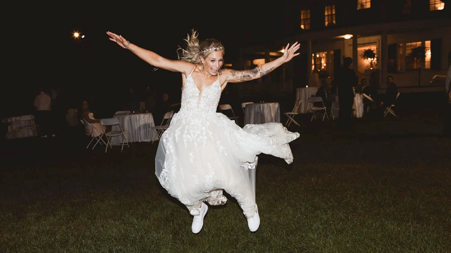 Boston Engagement Photography 1 Bride in sneakers leaps joyfully on dark lawn at night