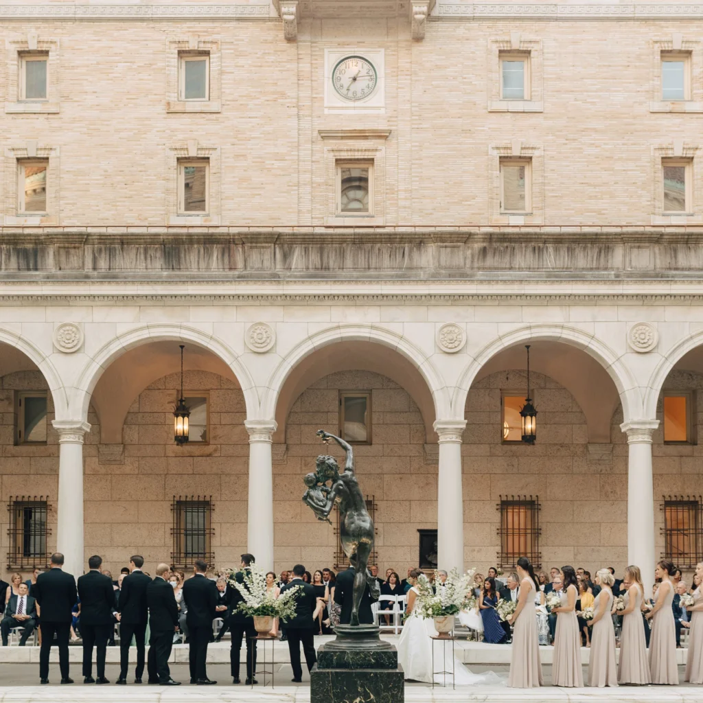 The full McKim courtyard of the Boston Public Library set for a wedding ceremony, arcade and fountain in view
