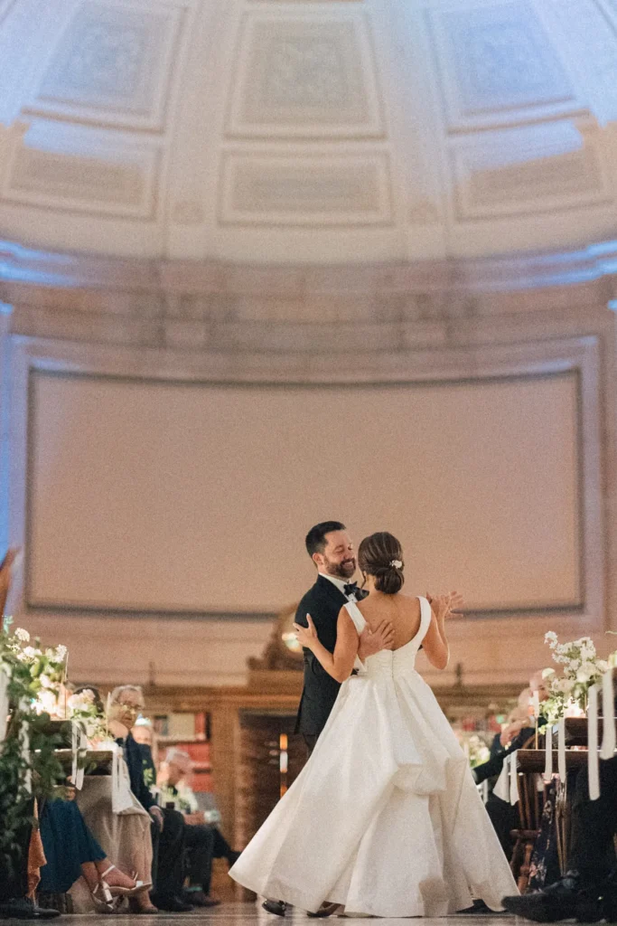 Bride and groom in the barrel-vaulted Bates Hall reading room of the Boston Public Library