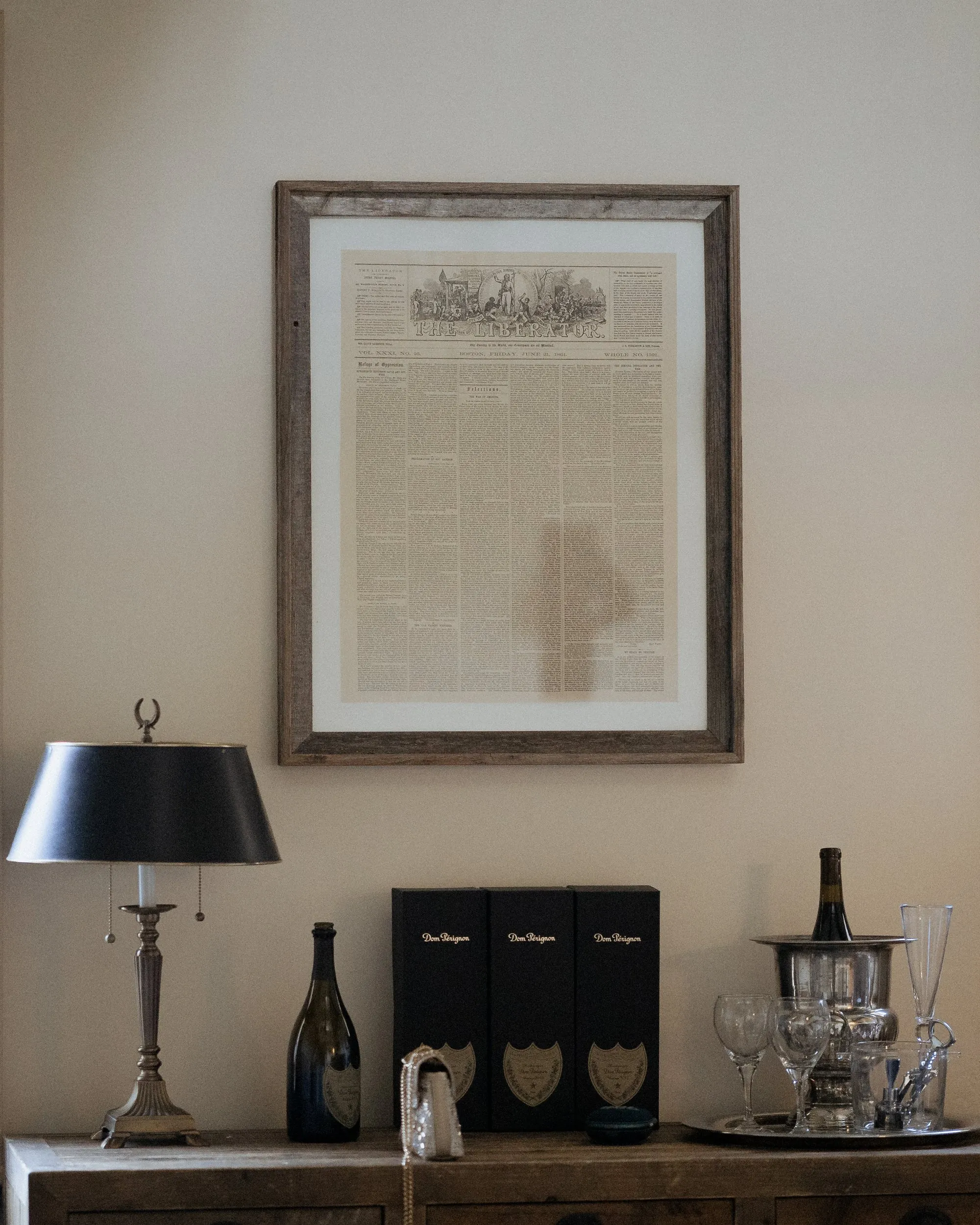 Champagne, glasses and a framed newspaper on the dresser in the wedding suite at the Garrison Inn, Newburyport