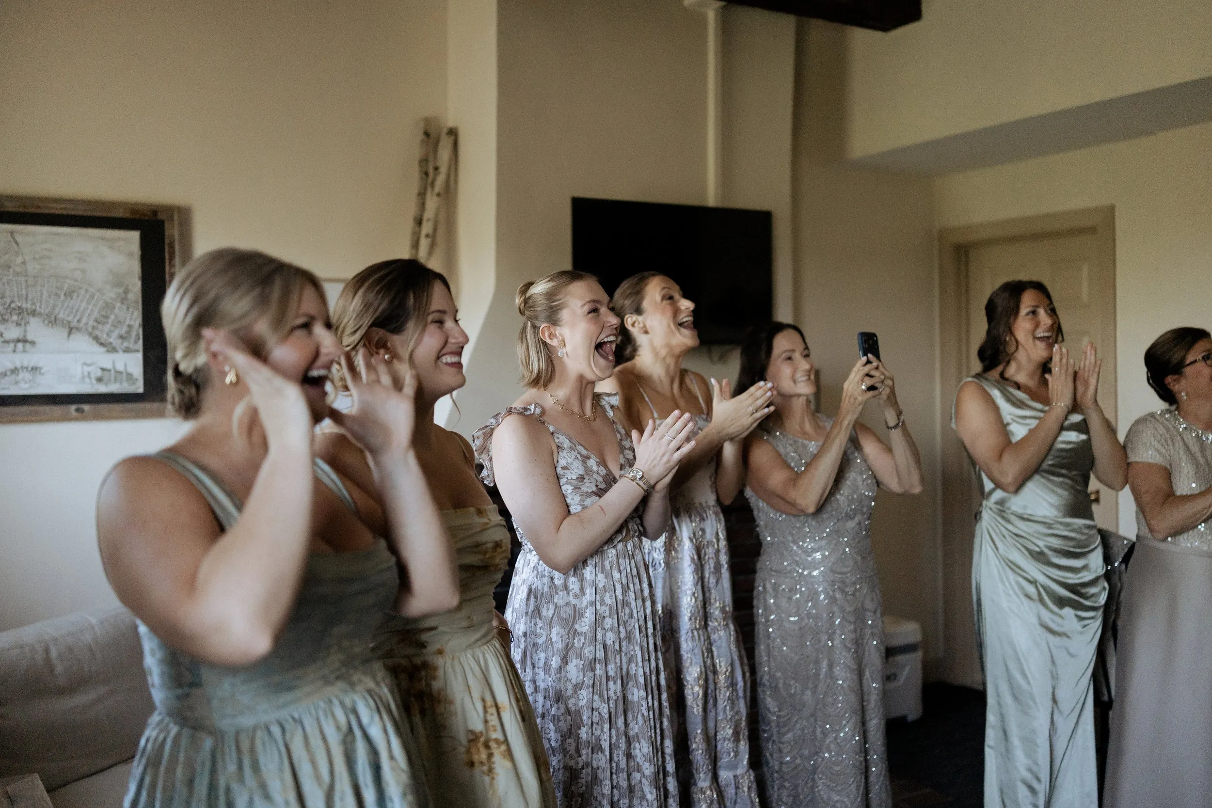 Bridesmaids reacting as the bride comes out in her dress at the Garrison Inn