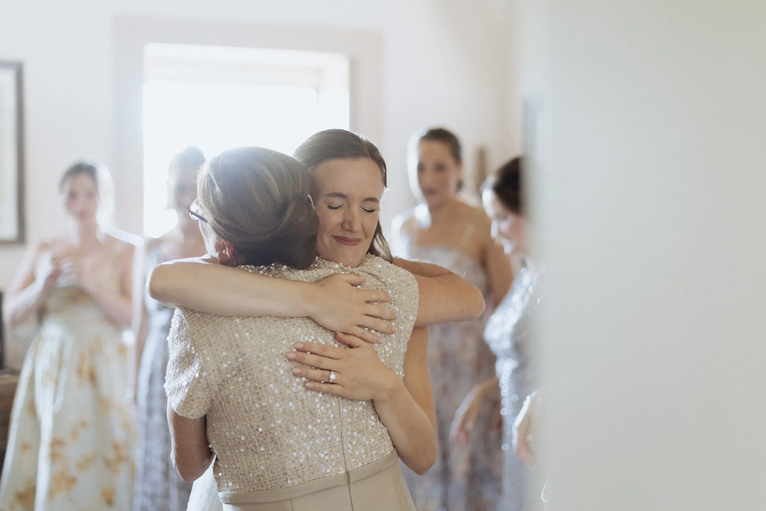 Bride hugging her mother while getting ready in Newburyport
