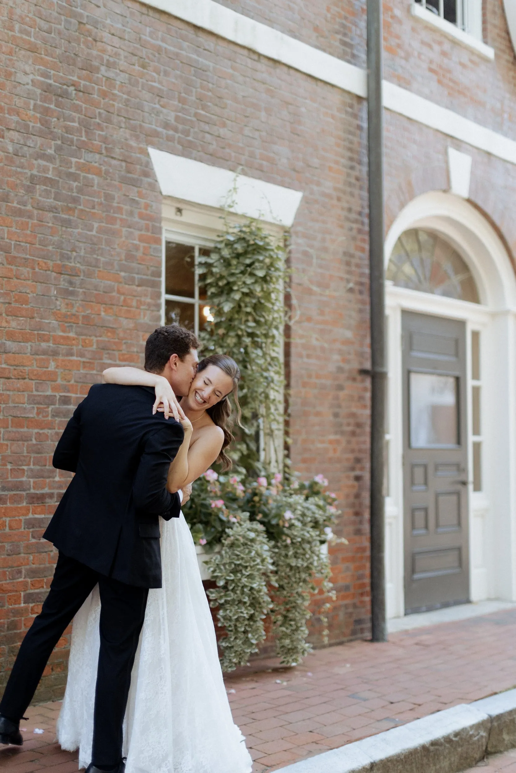 Groom dipping the bride for a kiss on a Newburyport sidewalk
