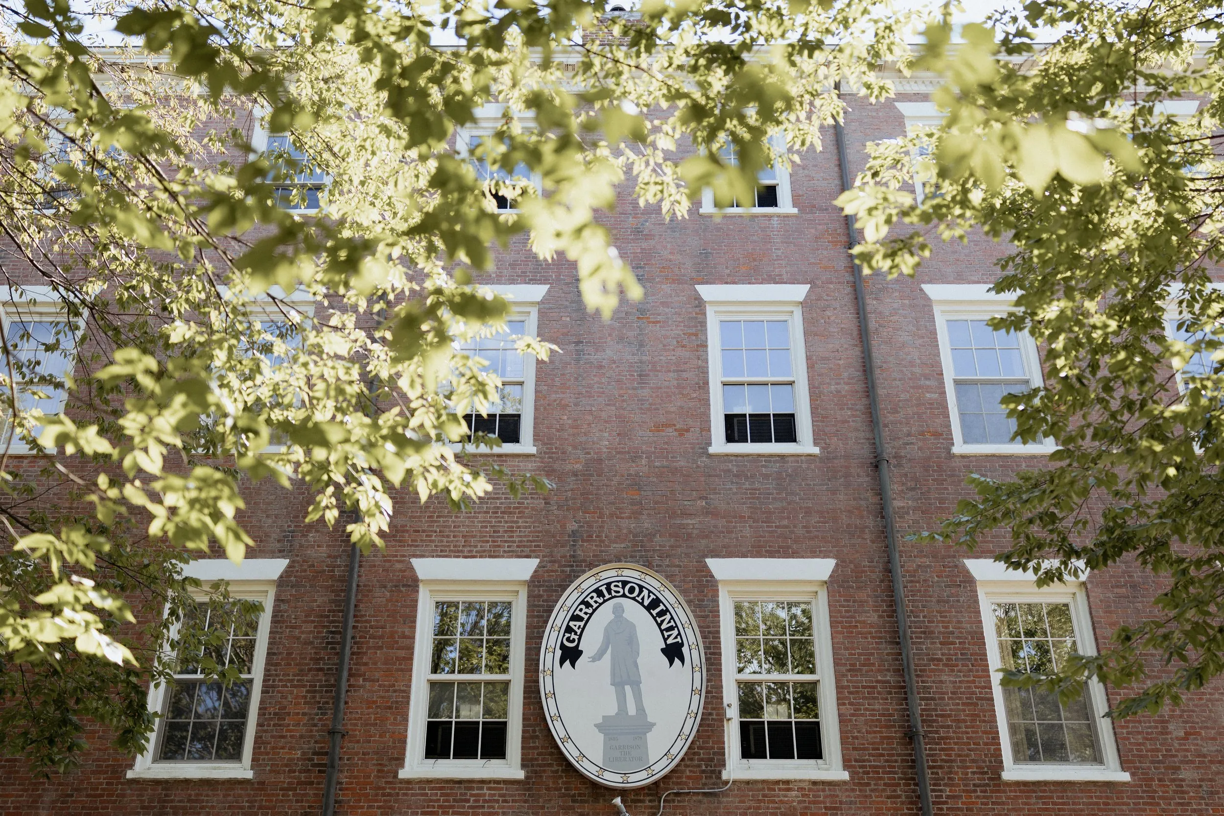 The Garrison Inn sign on the brick facade in Newburyport, Massachusetts