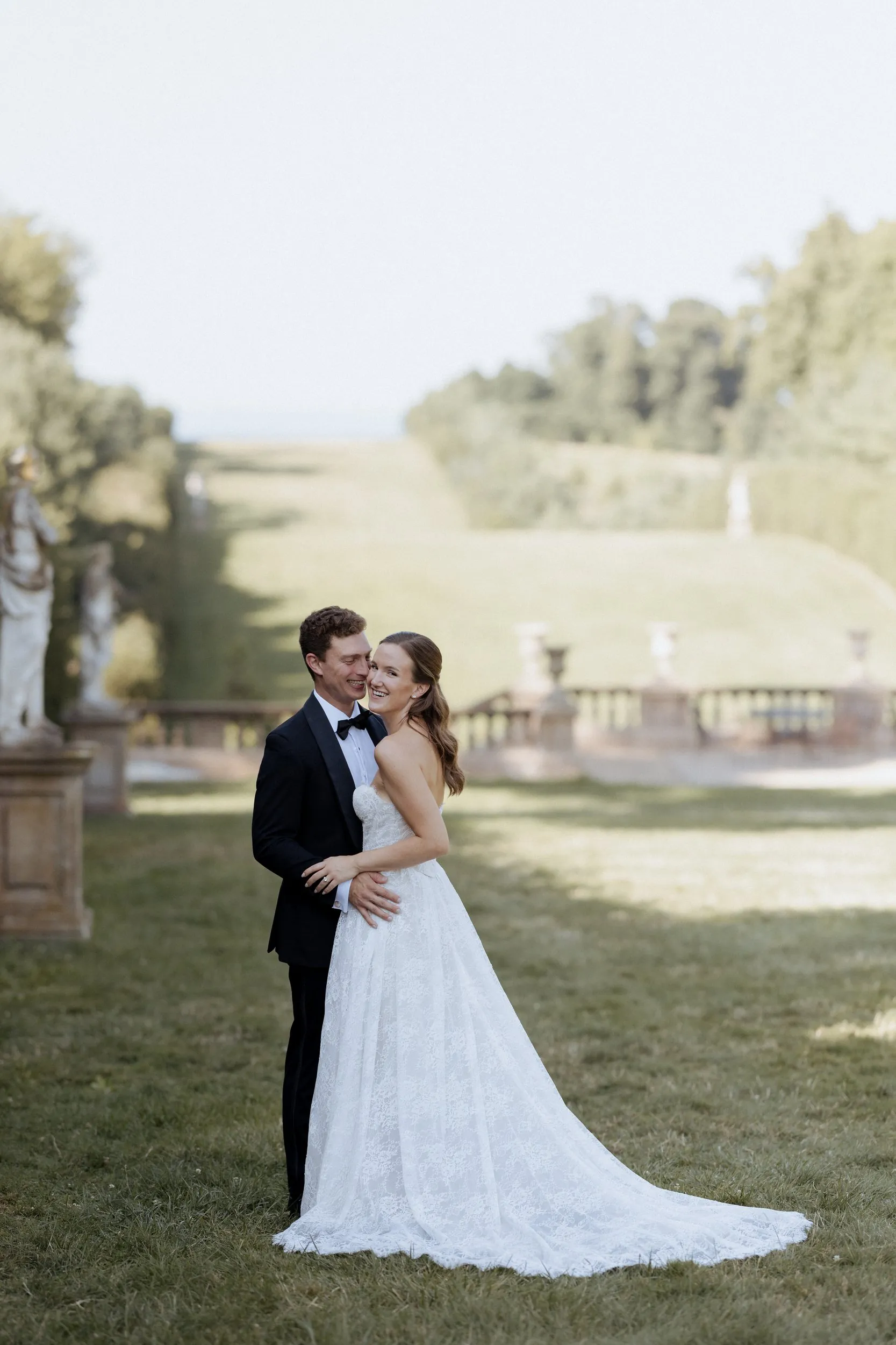 Bride and groom on the Grand All&eacute;e at the Crane Estate with the ocean behind them