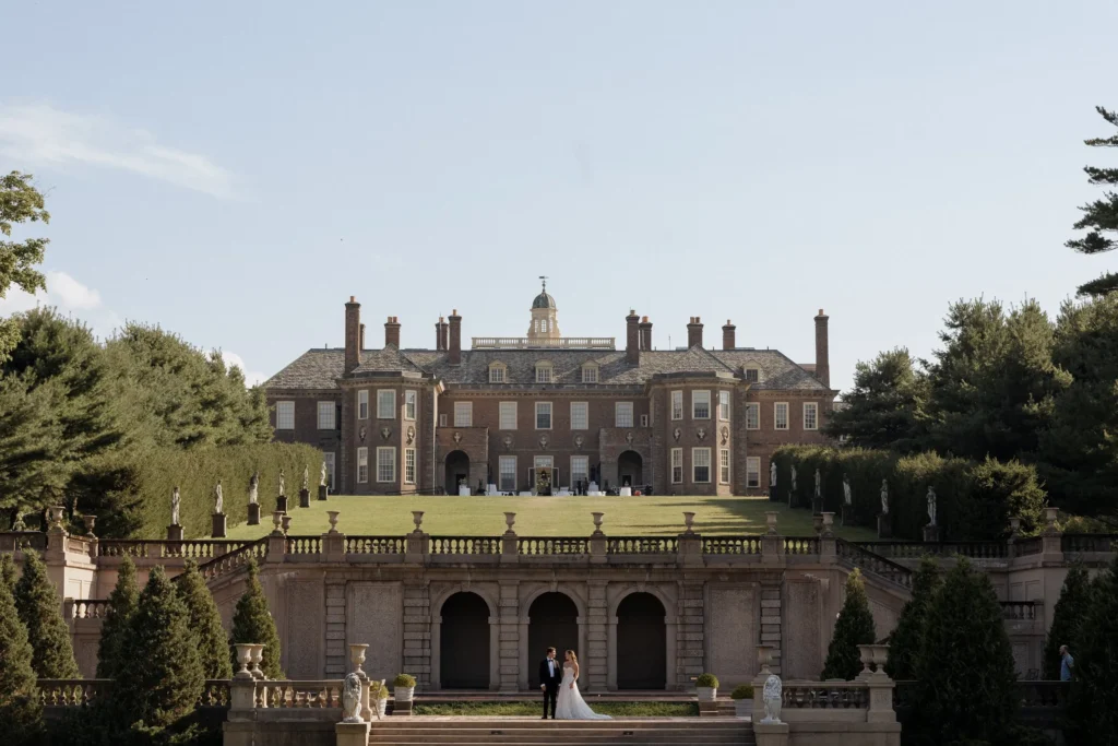 Boston Wedding Venues: 2027 Prices, Capacity & Real Photos 44 The Great House at Castle Hill on the Crane Estate, Ipswich, MA, with a couple on the lawn