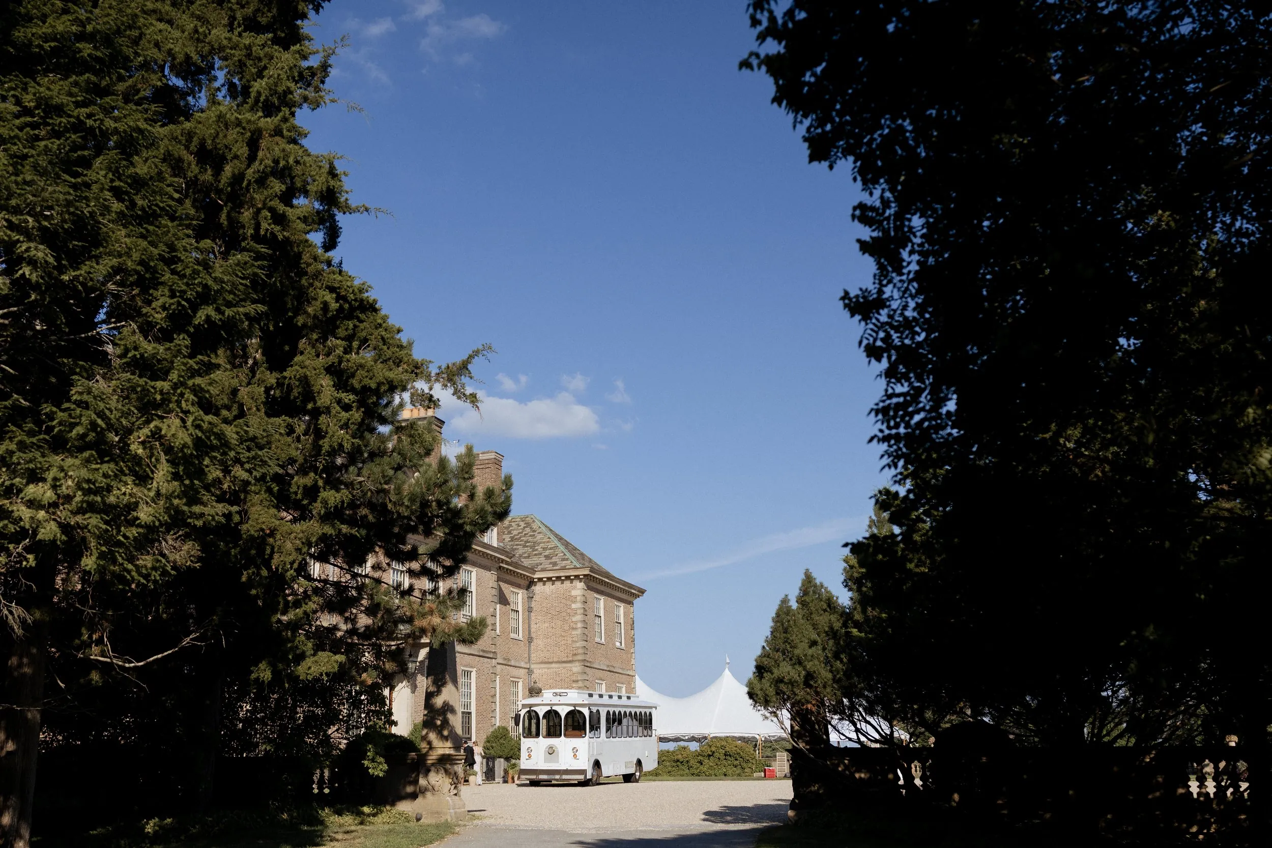 The Great House at the Crane Estate with the reception tent beside it, seen from the drive