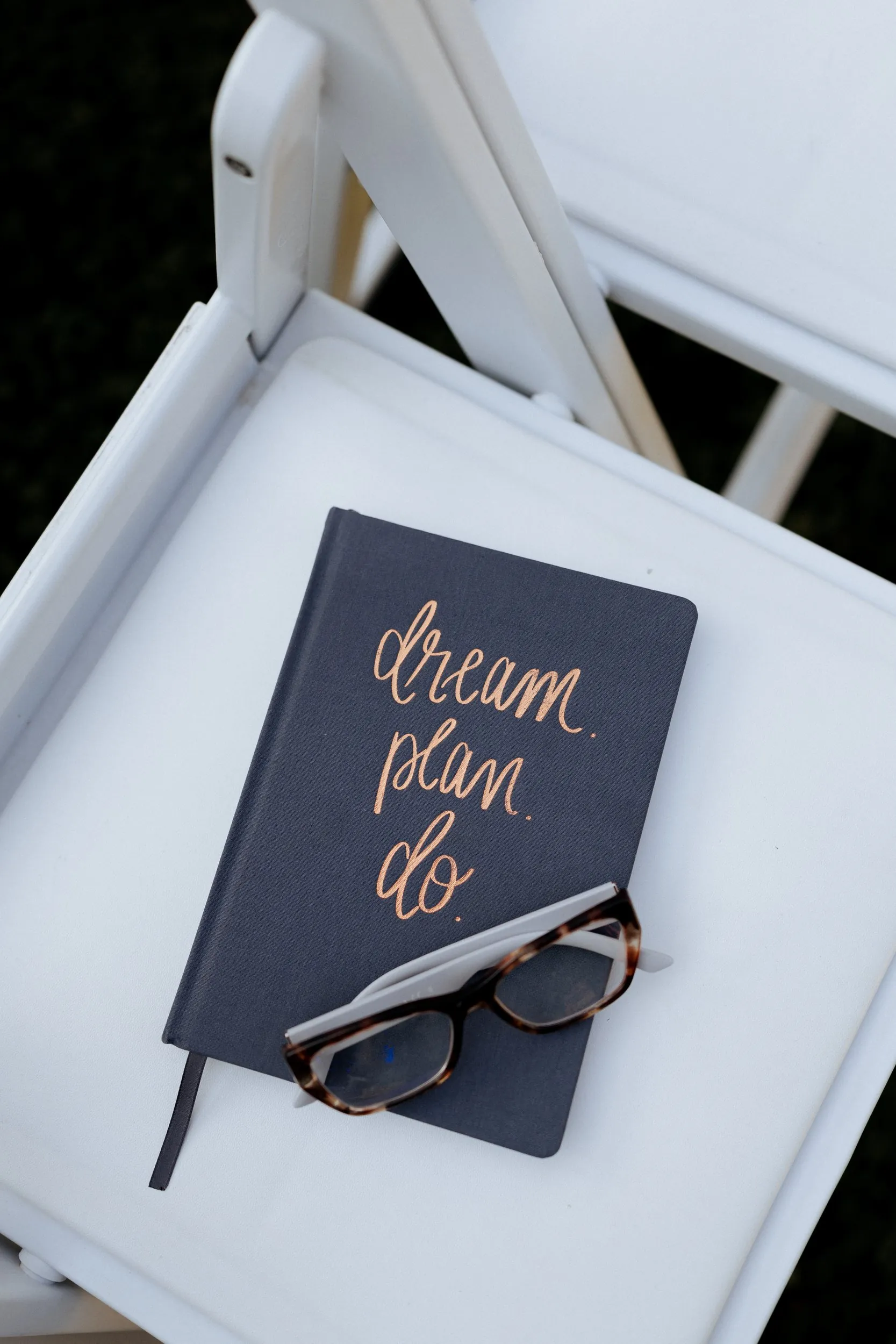Vow book reading dream, plan, do on a white chair before the ceremony