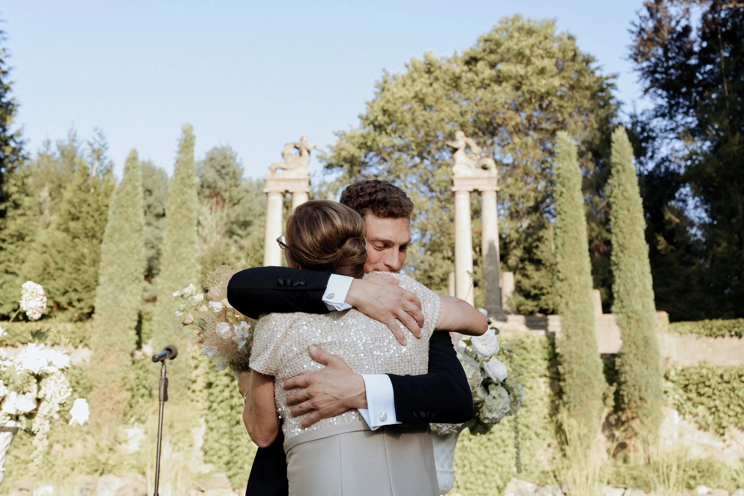 Groom hugging his mother at the front of the Italian Garden before the ceremony