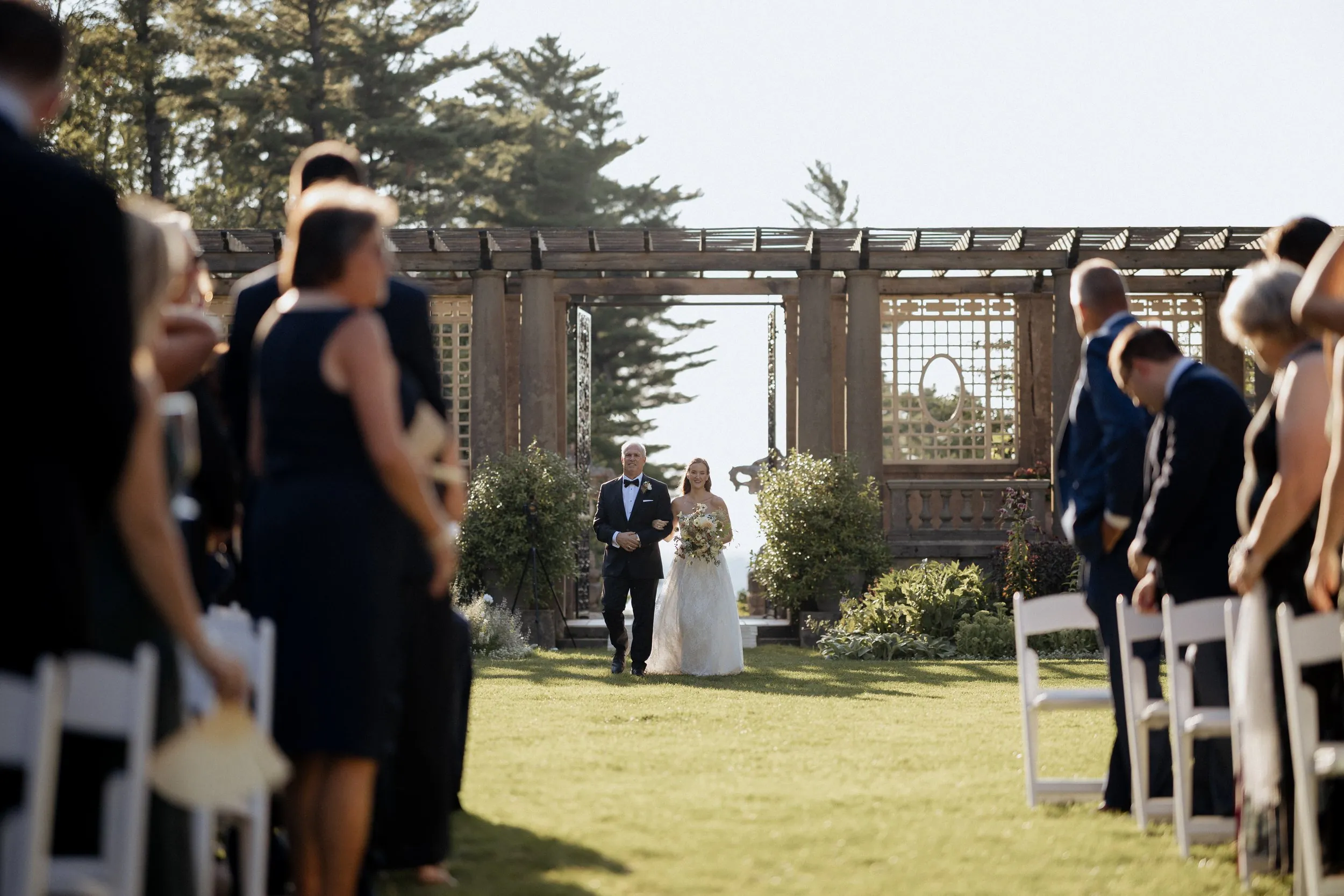 Bride and her father entering the Italian Garden through the pergola