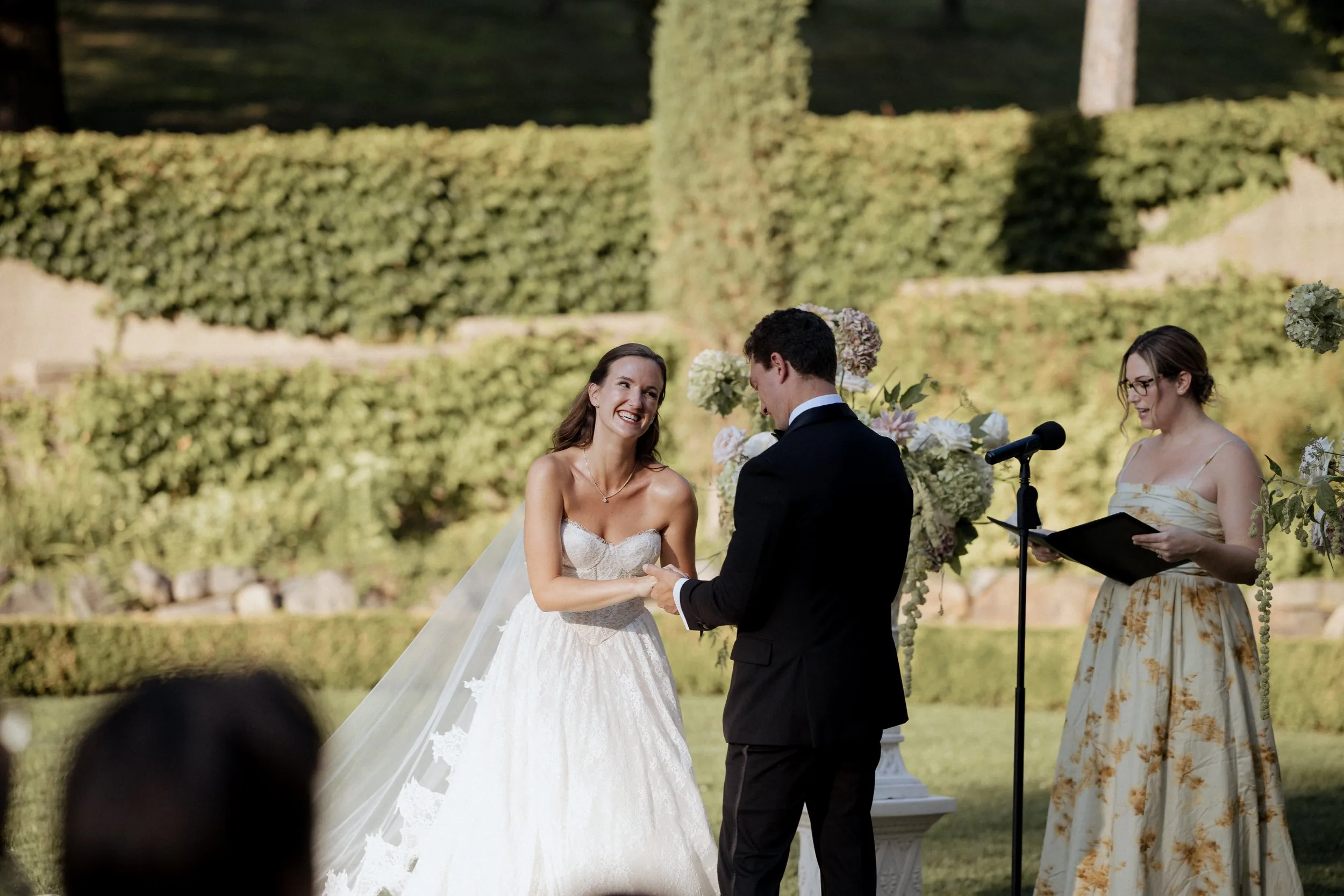 Bride and groom exchanging vows with the bride's sister officiating