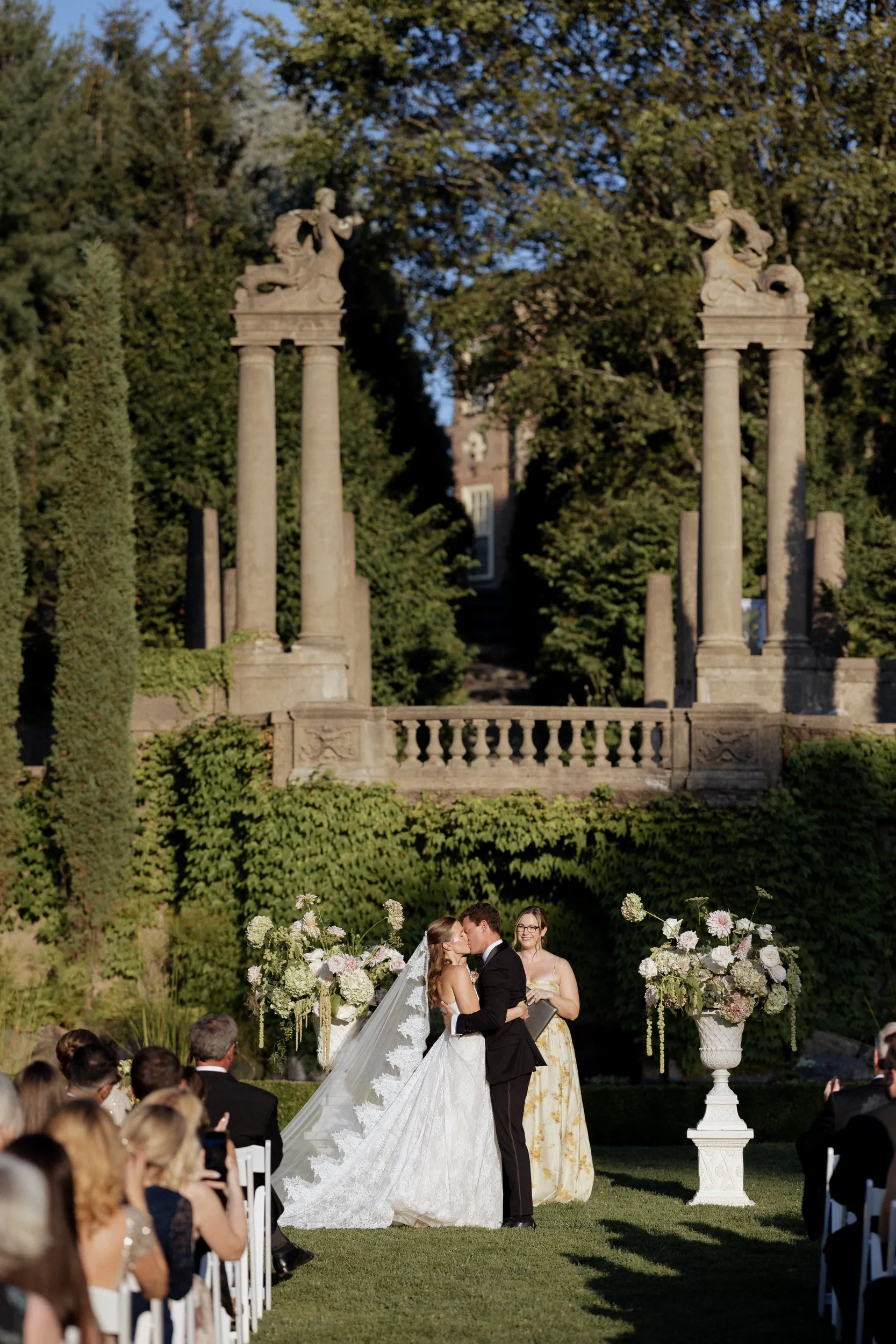 First kiss beneath the stone columns of the Italian Garden at Castle Hill