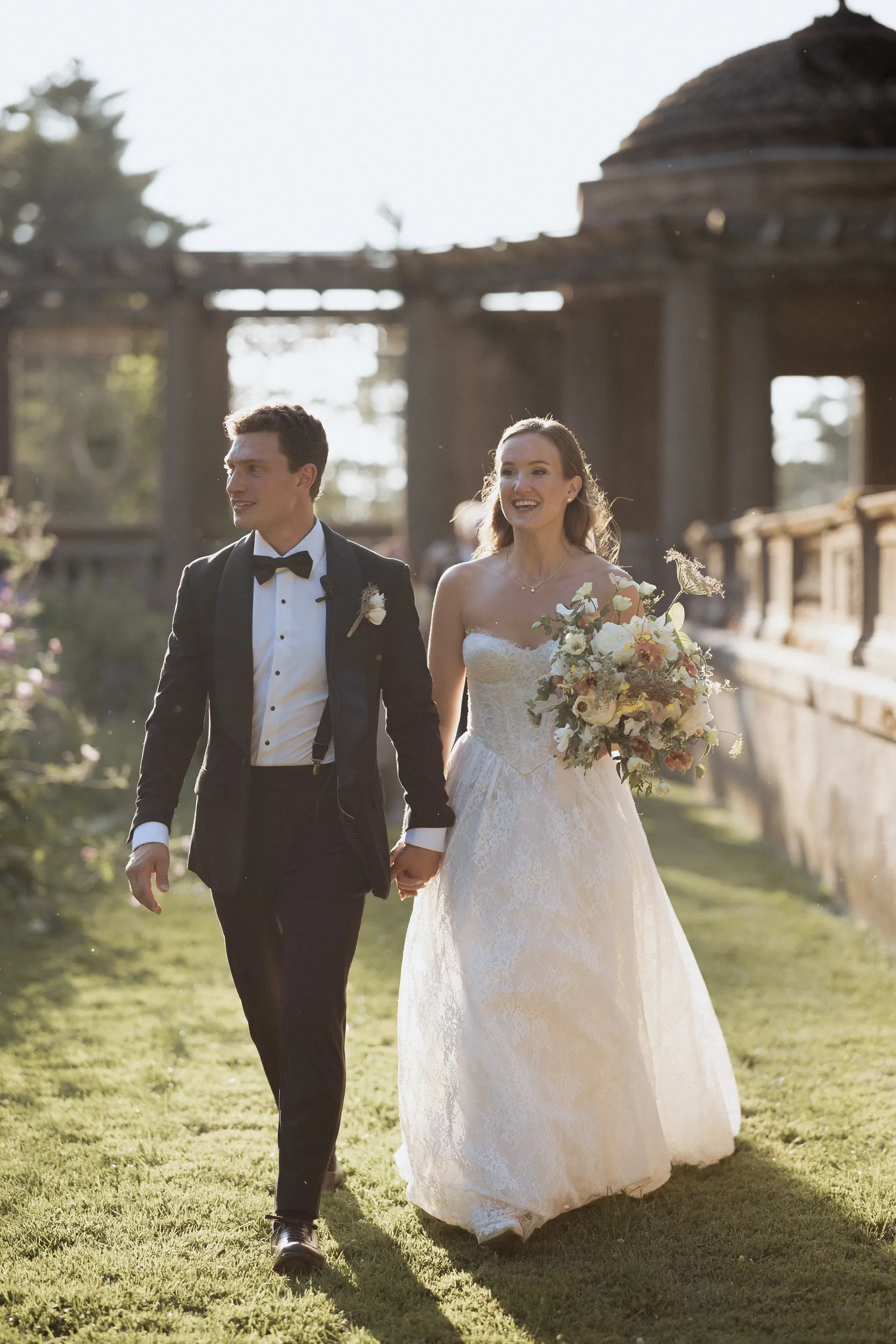Bride and groom walking through the Italian Garden after the ceremony