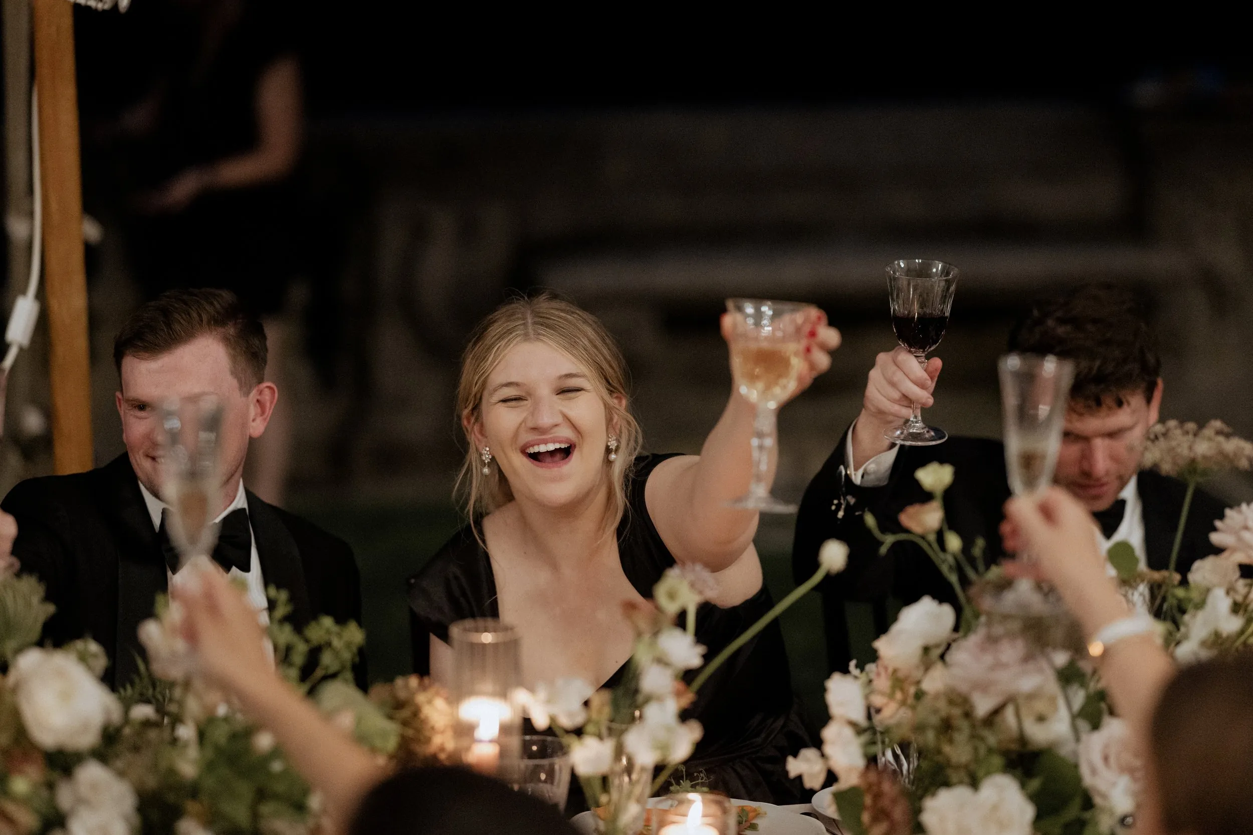 Guests raising glasses during the toasts under the tent