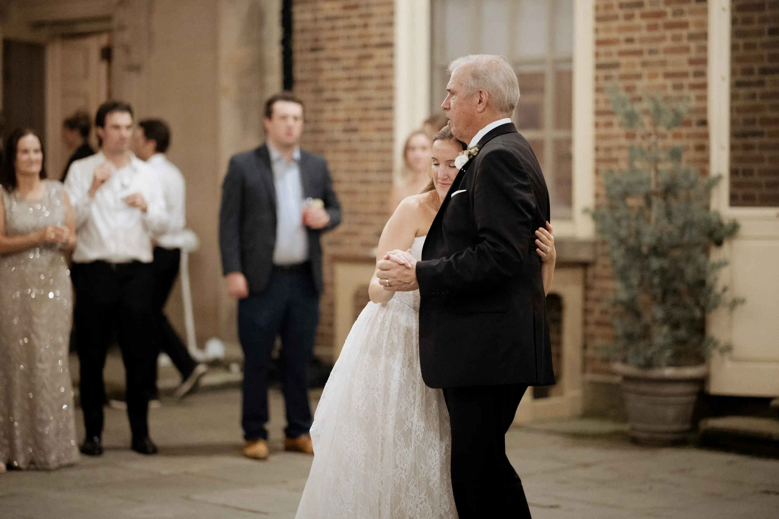 Father-daughter dance in the Great House courtyard