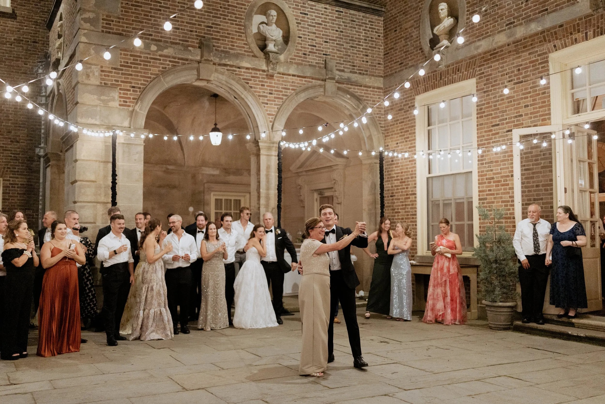 Guests filling the courtyard dance floor at the Crane Estate