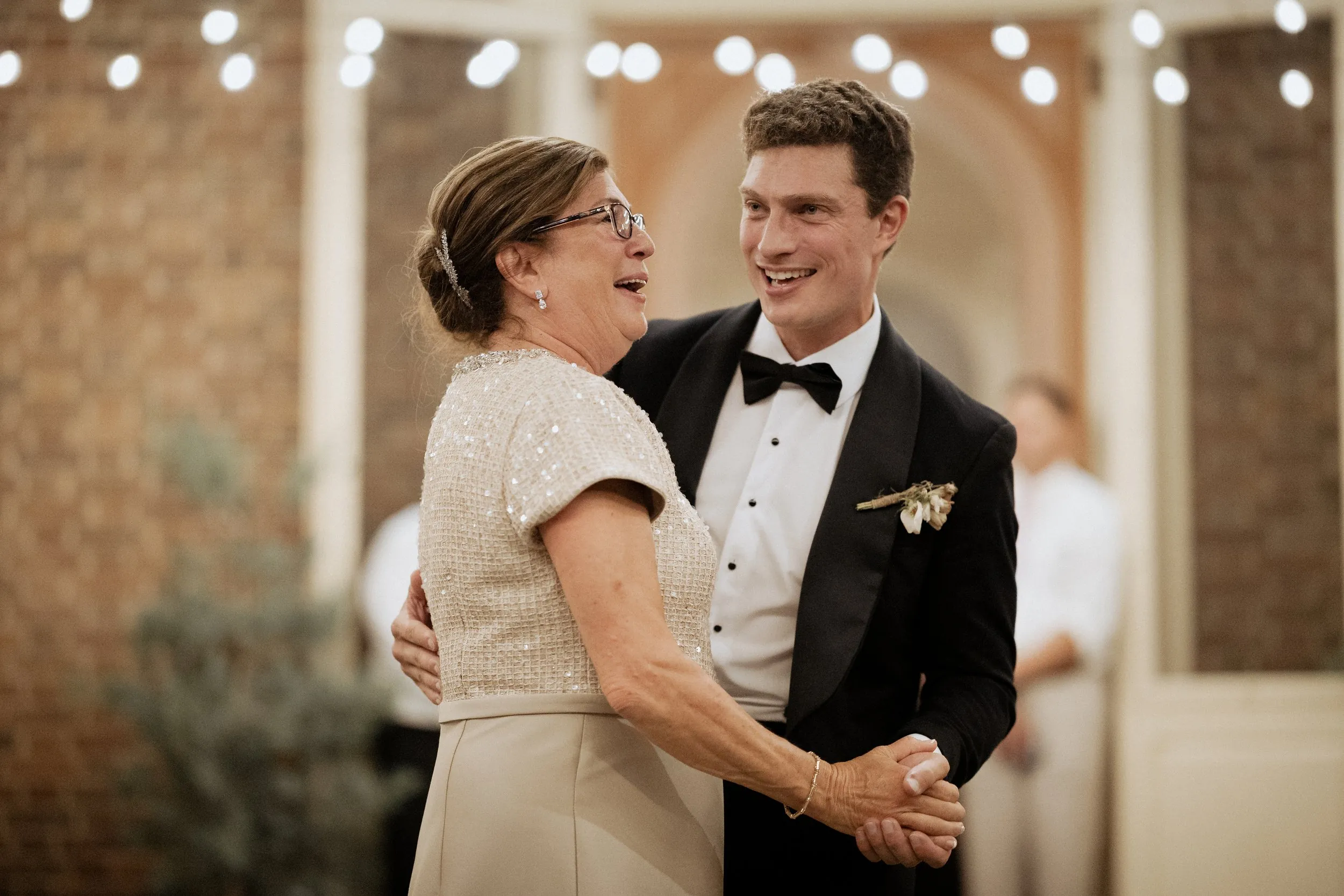 Groom and his mother laughing during their dance