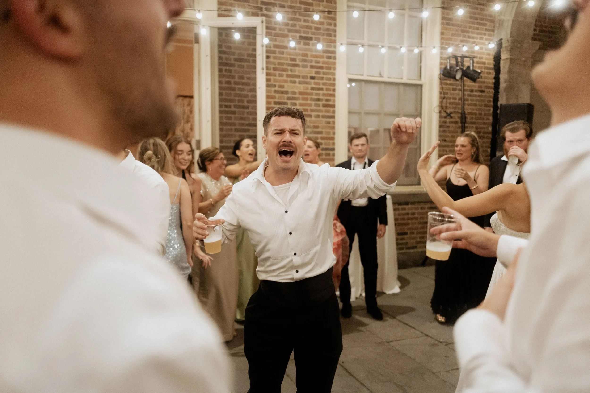 Guests singing along on the dance floor at a Crane Estate wedding