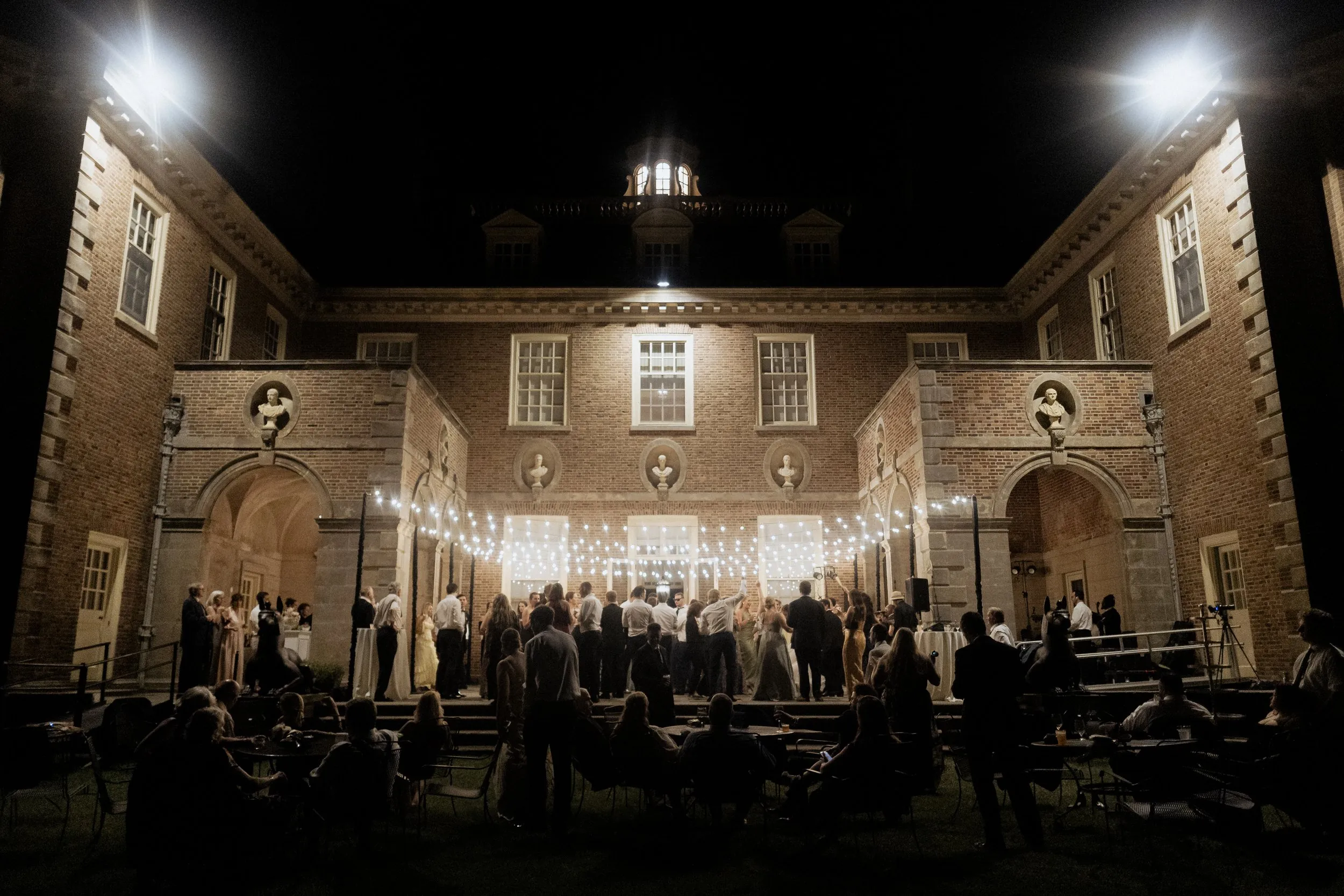 The Great House courtyard lit at night with the dance floor full