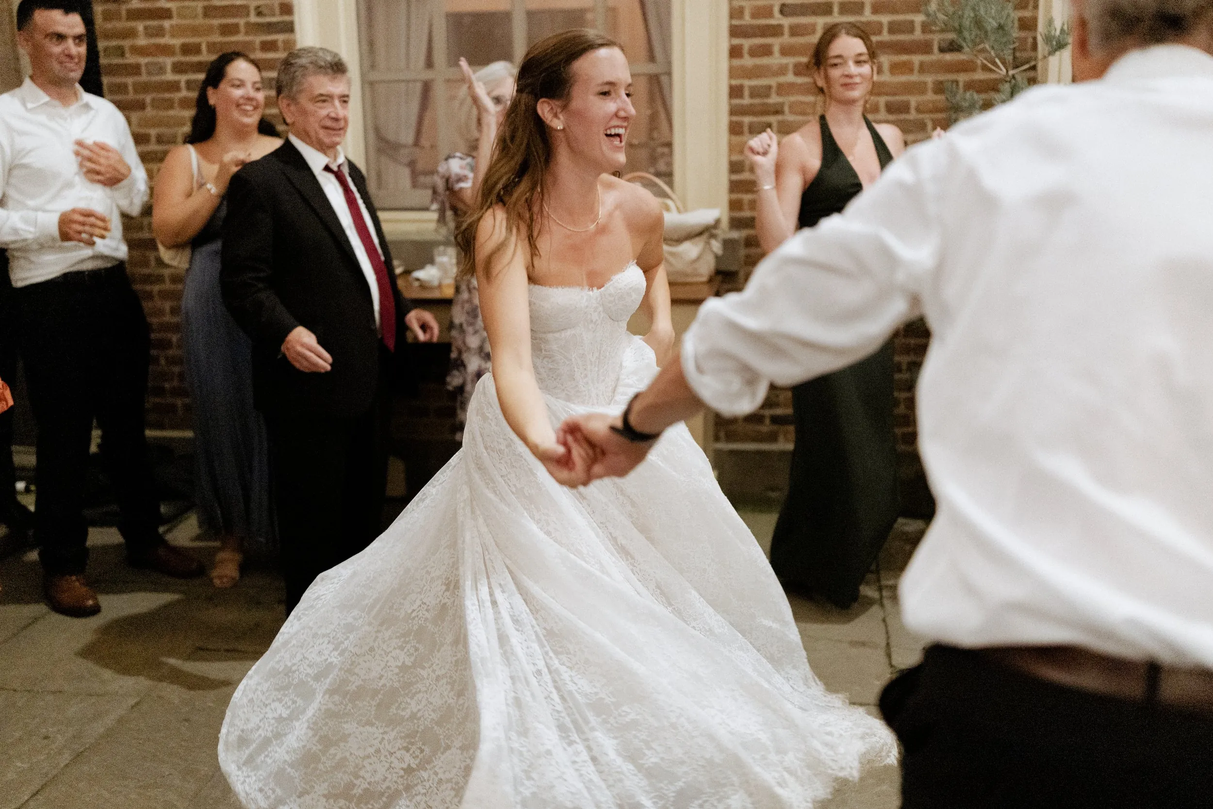 Bride spinning on the dance floor in the courtyard