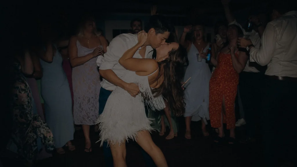 Groom dipping and kissing the bride on the dance floor at their Dennis Inn wedding reception on Cape Cod