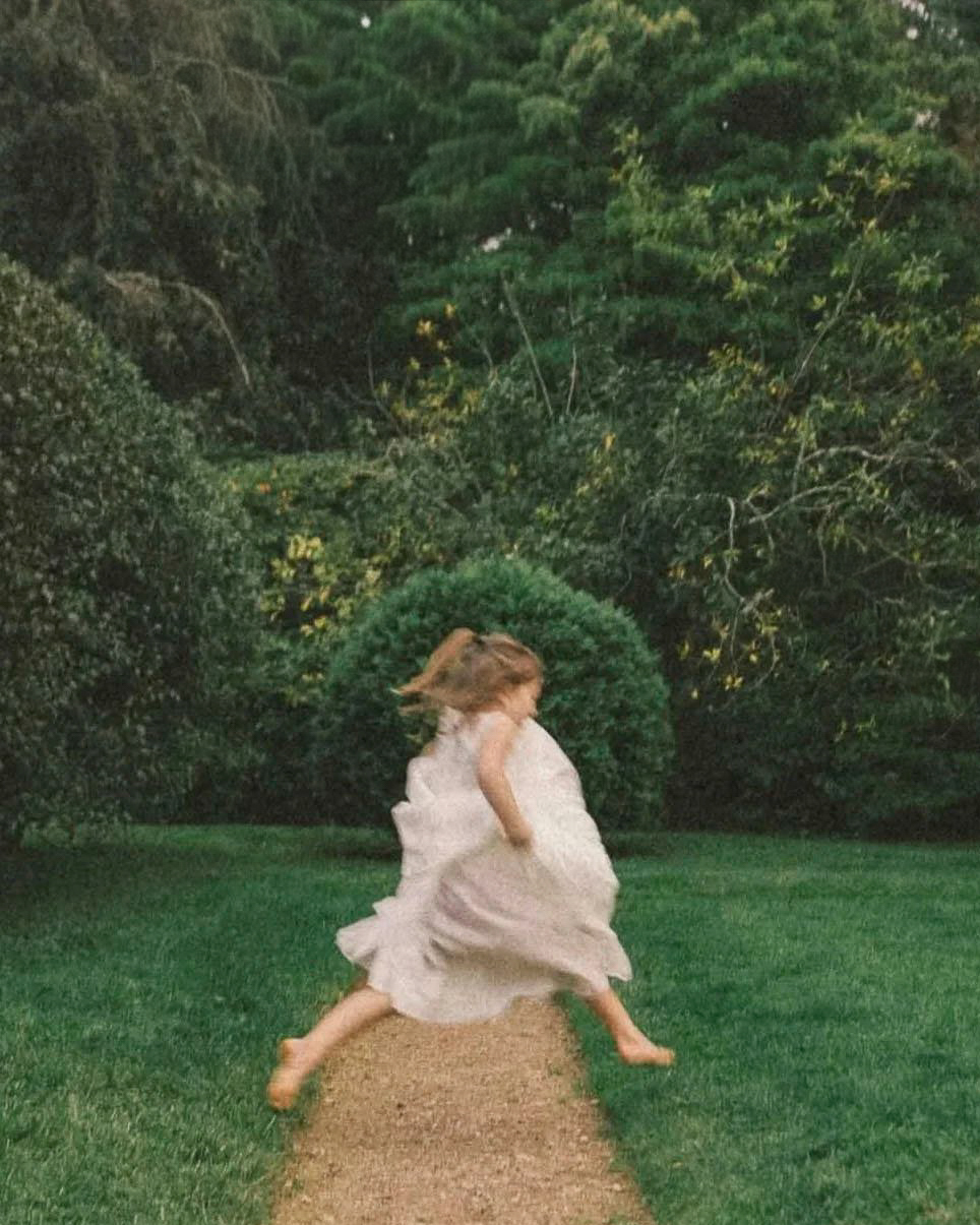 A flower girl runs across the lawn at Glen Magna Farms in Danvers
