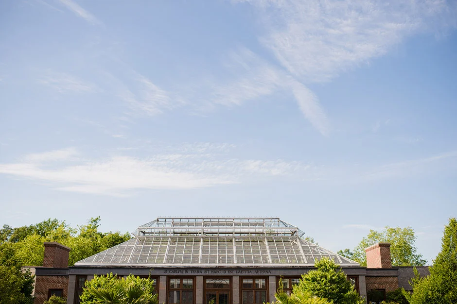 Exterior of the Orangerie conservatory at Tower Hill Botanic Garden under a blue summer sky, Boylston, MA