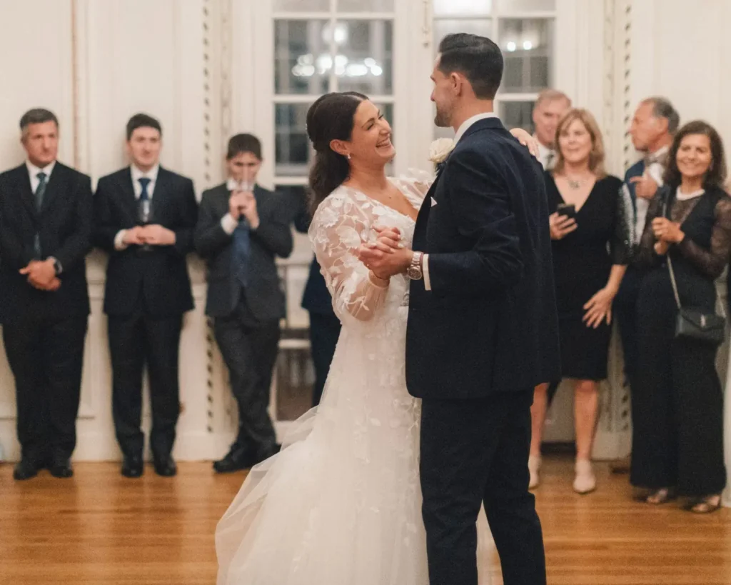 Bride and groom share their first dance in the Tupper Manor ballroom surrounded by guests