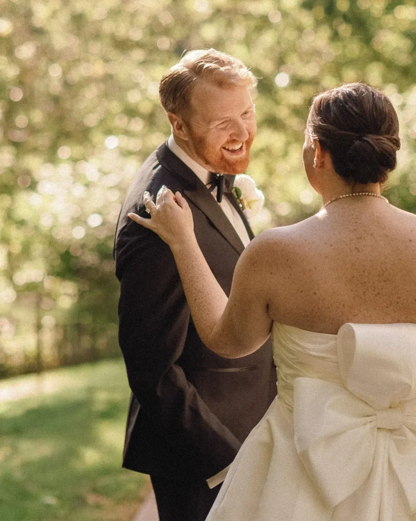 Groom laughs as he sees the bride for the first time during a first look on the grounds at Tupper Manor