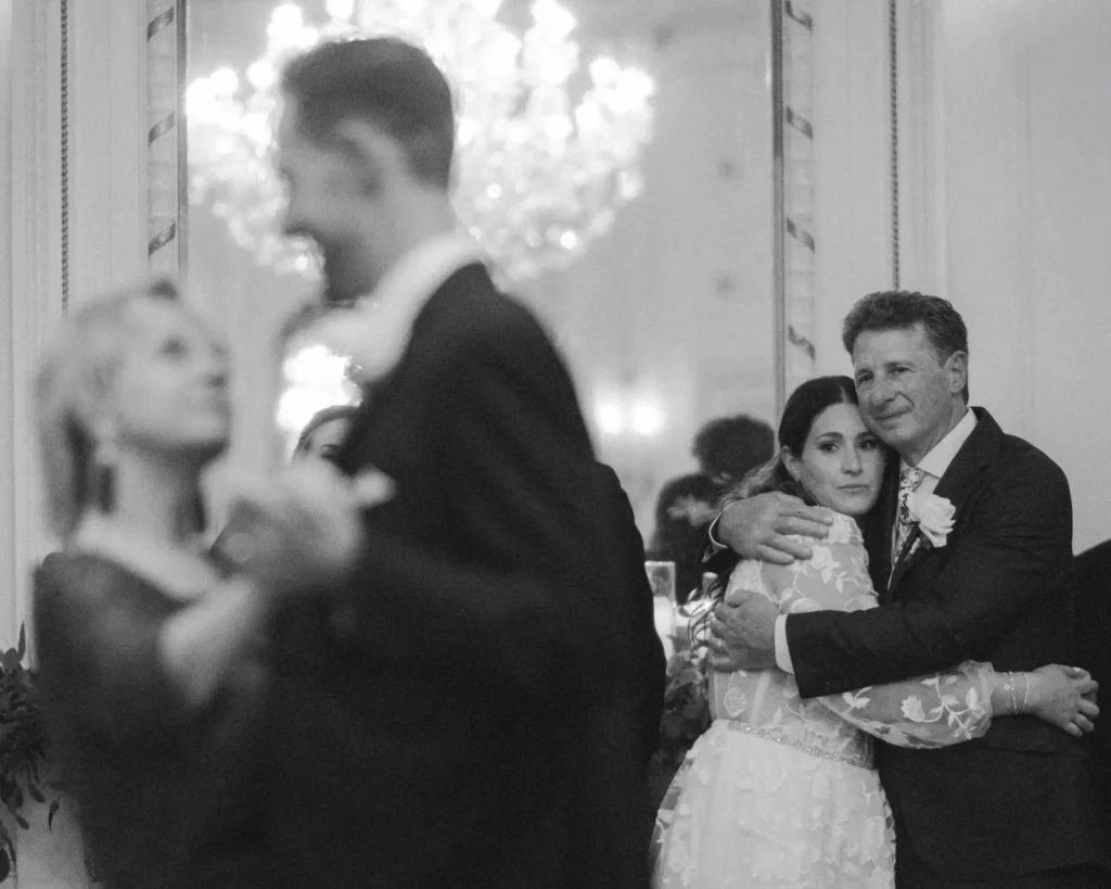 Black and white photo of the bride dancing with her father and the groom with his mother in the Tupper Manor ballroom